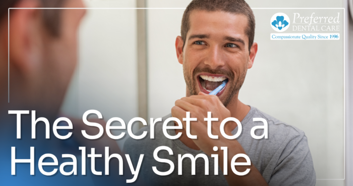 man brushing teeth in the mirror